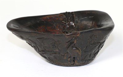 Lot 204 - A Chinese Rhinoceros Horn Libation Cup, Qing Dynasty, of shaped oval form, the exterior carved...