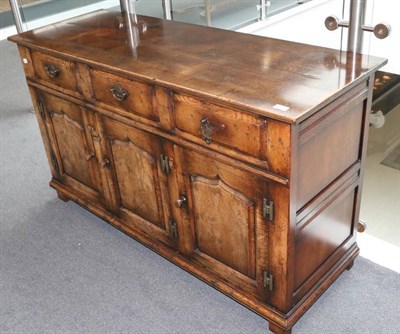 Lot 552 - Chapman's of Siesta House: An Oak Sideboard, modern, with two drawers above two fielded...