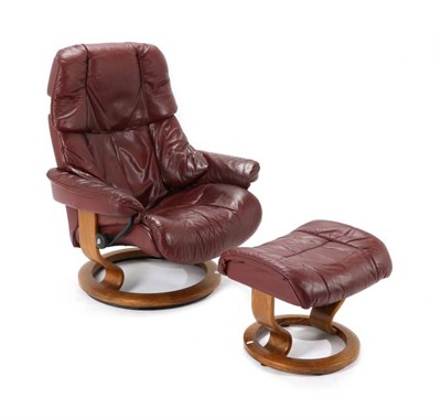 Lot 565 - An Ekornes Stressless Leather Reclining Chair and Footstool, in red leather, chair 85cm,...