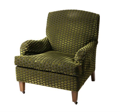 Lot 568 - Verve Designs Ltd: A Green Velvet Spotted Easy Chair, modern, on square tapering legs with castors