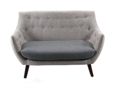 Lot 570 - A Two-Seated Button Grey Sofa, modern, of curved form with contrasting grey cushion, on walnut...