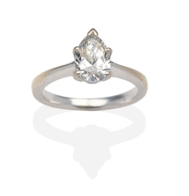 Lot 296 - A Pear Cut Diamond Solitaire Ring,  in a white claw setting, to knife edge shoulders on a plain...