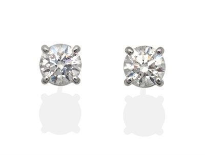 Lot 303 - A Pair of 18 Carat White Gold Diamond Solitaire Earrings, a round brilliant cut diamond in a...