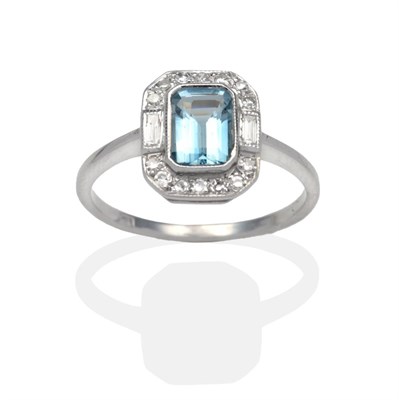 Lot 312 - An Aquamarine and Diamond Ring, an octagonal cut aquamarine within a border of eight-cut and...