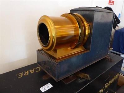 Lot 1276 - Magic Lantern Stamped 'Made In London' with 7'' brass lens, with electric lamp in fitted wooden...