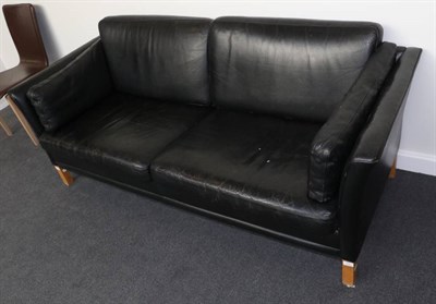 Lot 584 - A 1970s Danish Design Two-Seater Sofa, upholstered in black leather with six cushions and...