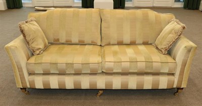 Lot 586 - Kirkdale: A Three Seater Sofa Upholstered in Yellow and Gold Stripped Fabric, Modern, raised on...