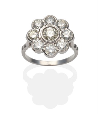 Lot 409 - A Diamond Cluster Ring, a round brilliant cut diamond within a border of smaller round...