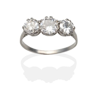 Lot 415 - A Diamond Three Stone Ring, graduated round brilliant cut diamonds in white claw settings above...