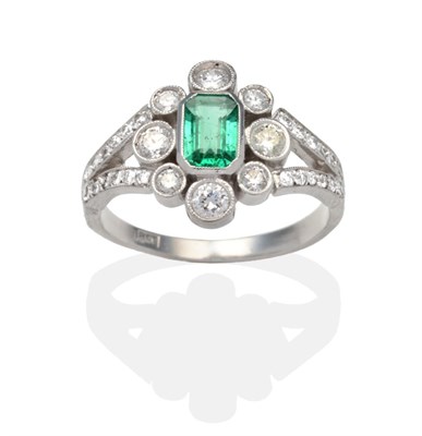 Lot 425 - An Emerald and Diamond Cluster Ring, an octagonal cut emerald within a border of round...