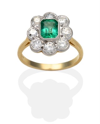 Lot 428 - An Emerald and Diamond Cluster Ring, an octagonal cut emerald within a border of round...