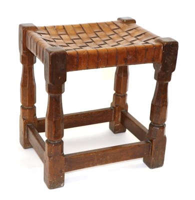 Lot 595 - A Robert  "Mouseman " Thompson Oak Stool, with lattice leather top, on four octagonal legs...