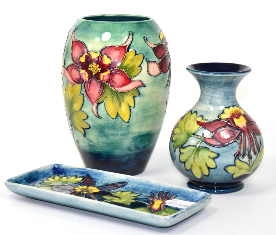 Lot 46 - Moorcroft pottery including two vases and a rectangular dish, all in Columbine pattern, tallest...