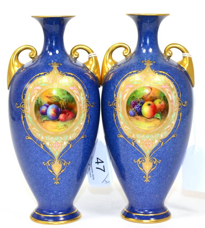 Lot 47 - A pair of Royal Worcester porcelain vases each with powder blue ground and decorated with vignettes