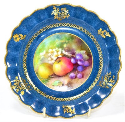 Lot 48 - A Royal Worcester porcelain plate with a powder blue ground decorated with fruit and signed H...