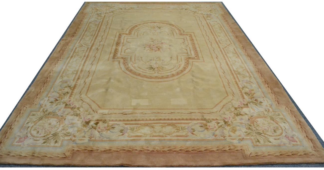 Lot 798 - Savonnerie Design Carpet China, circa 2000 The cream field with a central oval floral panel...