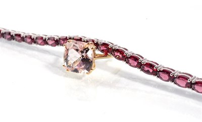 Lot 81 - A 9 carat gold morganite ring, finger size P1/2, 3.1g and a silver oval cut garnet line...