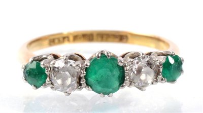 Lot 172 - An emerald and diamond half hoop ring, three graduated round cut emeralds, spaced by old cut...