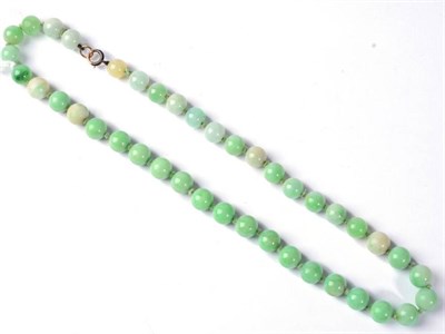 Lot 280 - A jade bead necklace, uniform round jade beads knotted to a spring ring clasp, length 45cm,...