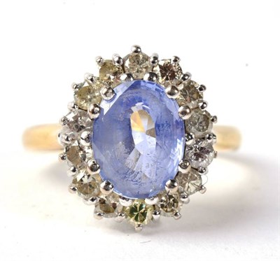 Lot 282 - An 18 carat gold sapphire and diamond cluster ring, an oval cut sapphire within a border of...