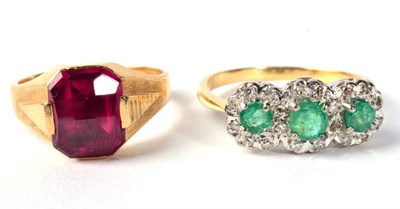 Lot 285 - An emerald and diamond triple cluster ring, finger size R, 4.1g and a synthetic ruby ring,...