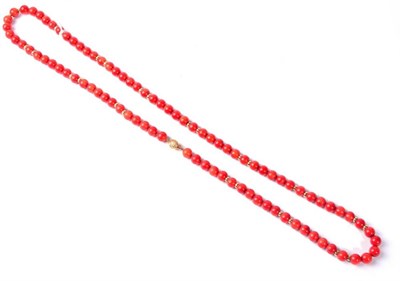 Lot 291 - A red coral bead necklace, uniform red coral beads with gold spacer beads, to a fluted ball...