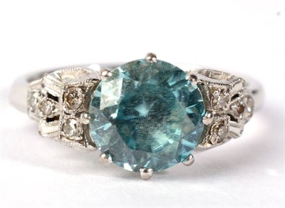 Lot 298 - An Art Deco blue zircon and diamond ring, a round cut blue zircon to pierced and gain set...