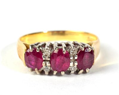 Lot 304 - An 18 carat gold diamond and ruby set ring