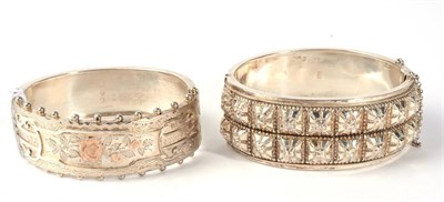 Lot 309 - A Victorian silver cuff bangle, the front with a raised square motif, measures 4.8cm by 5.8cm inner