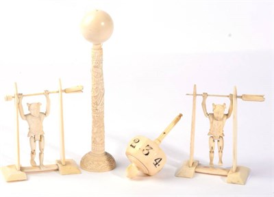 Lot 323 - A Victorian ivory spinner dice; an early 20th century carved ivory cup and ball toy; and two...