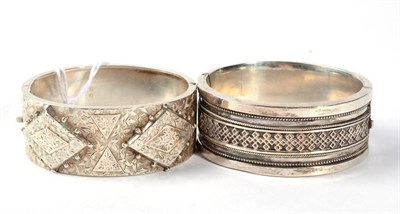 Lot 334 - A Victorian silver cuff bangle, the front applied plaques with beaded edges, with overall...