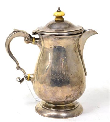 Lot 336 - A late Victorian silver hot water jug, London 1898, of baluster form in the George III style,...