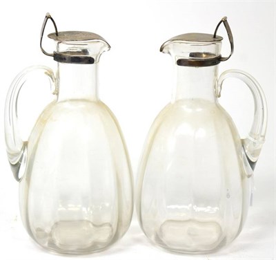 Lot 337 - A pair of silver plate mounted glass claret jugs, the mounts mark of Hukin & Heath and stamped...