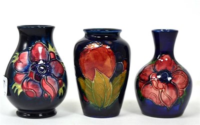 Lot 347 - A William Moorcroft Pomegranate pattern vase, on a blue ground, impressed factory marks, 9.5cm; and