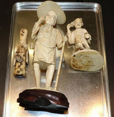 Lot 384 - An early 20th century Japanese ivory okimono of peasant with staff; an okimono of a child...