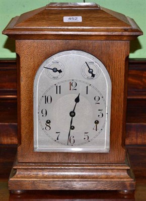 Lot 452 - An oak chiming mantel clock