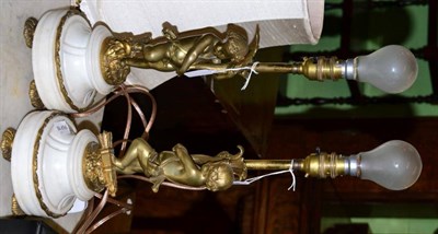 Lot 455 - A pair of French gilt-metal table lamps, in the form of cherubs holding aloft cornucopia, raised on