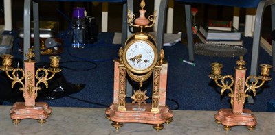 Lot 457 - A French rough marble and gilt metal mounted striking clock garniture, late 19th century, of...