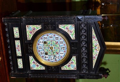 Lot 458 - An Aesthetic movement ebonised and ceramic mounted striking table clock