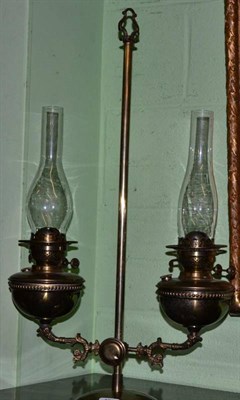 Lot 462 - An adjustable twin branch oil lamp