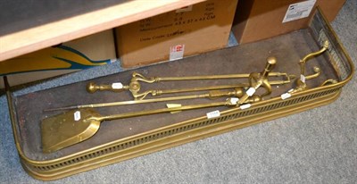 Lot 1184 - A group of fire implements, comprising, three fire irons, pair of fire dogs and a fender