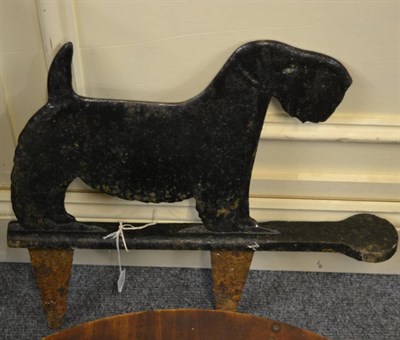 Lot 1223 - A cast iron boot scraper modelled as a Scottish terrier