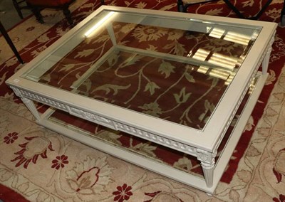 Lot 1225 - A cream painted Coffee Table, on carved and tapering legs joined by a stretcher, 133cm by 100cm...