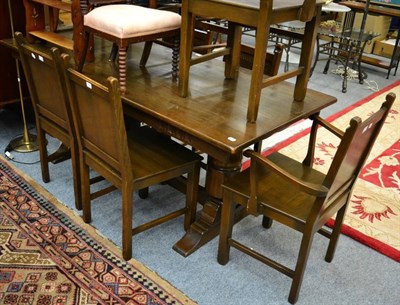 Lot 1242 - A reproduction dining table together with six dining chairs (4+2) (7)