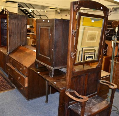 Lot 1244 - An early 19th century mahogany drop leaf table; an Edwardian mirror back hall stand; a 19th century