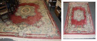 Lot 1273 - A Chinese carved carpet of Savonnerie design, the pale raspberry field of floral design, 360cm...