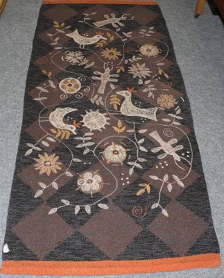 Lot 1277 - A rug decorated with a design of birds, flowers and insects, with orange borders