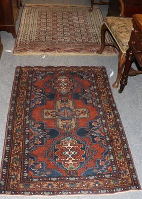 Lot 1285 - Azeri rug Iranian Azerbaijan, the madder field with three medallions enclosed by stellar motif...