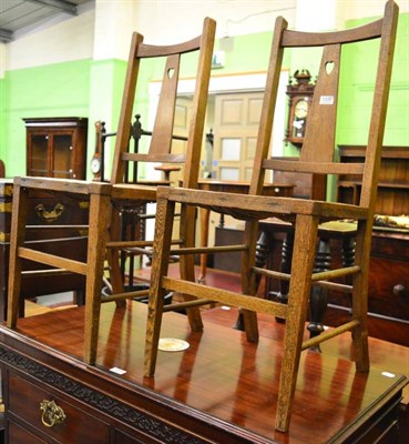 Lot 1335 - A pair of Arts & Crafts oak side chairs with rush seats