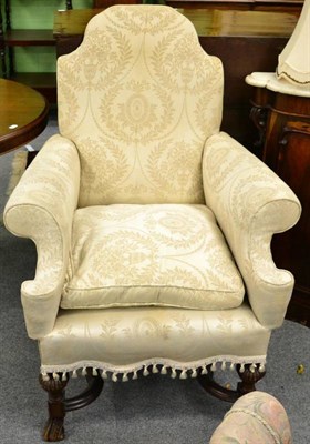 Lot 1365 - An 18th century style armchair upholstered in cream coloured fabric, decorated with floral urn...